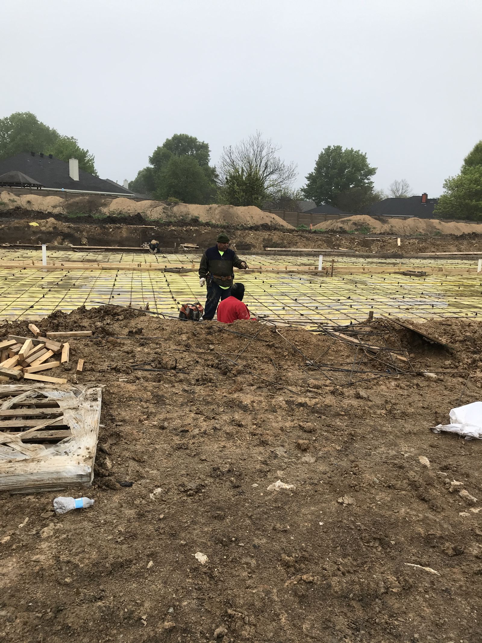 1A2B Construction crew on site tying rebar and formwork